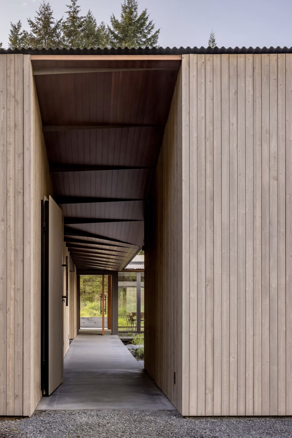 A cedar-clad breezeway with a continuous wood soffit