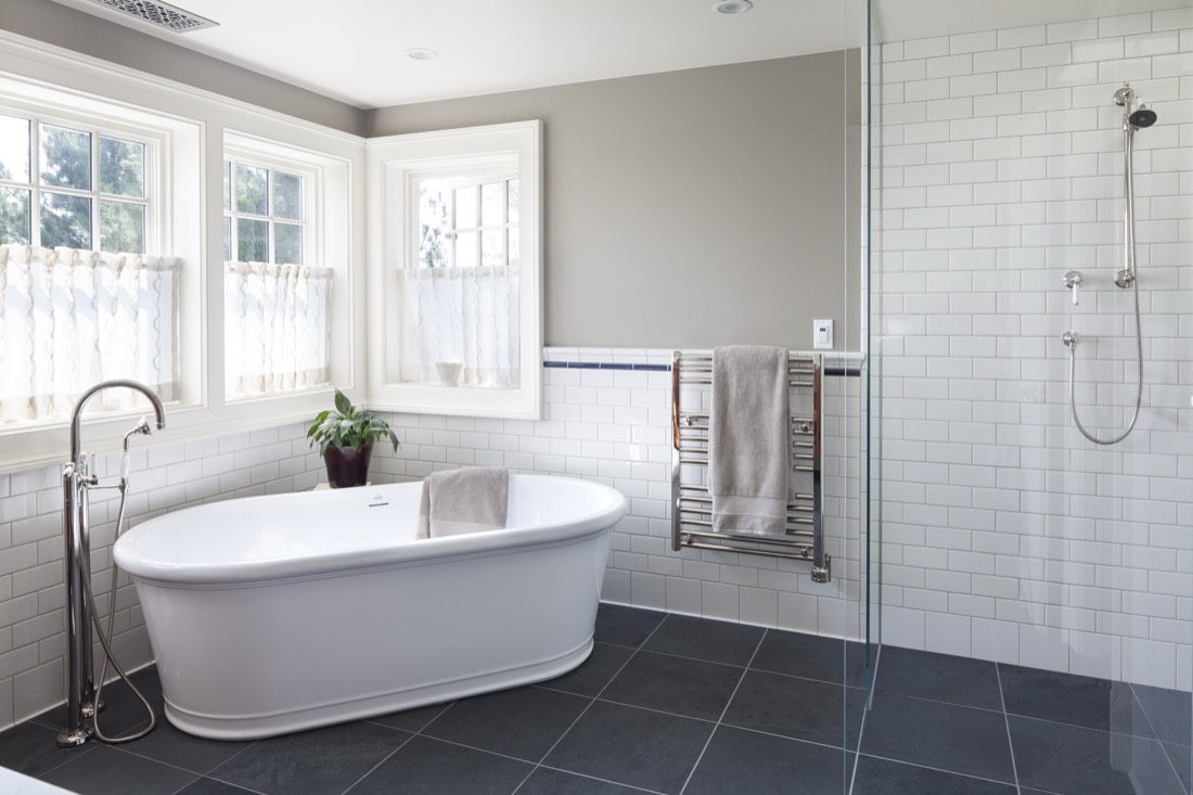 A bright bath with tile and a freestanding tub