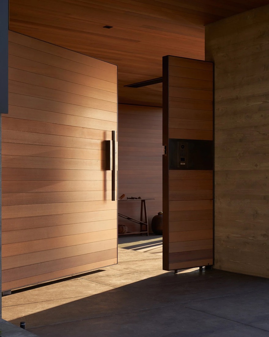 Wood-lined hall with a pivot door